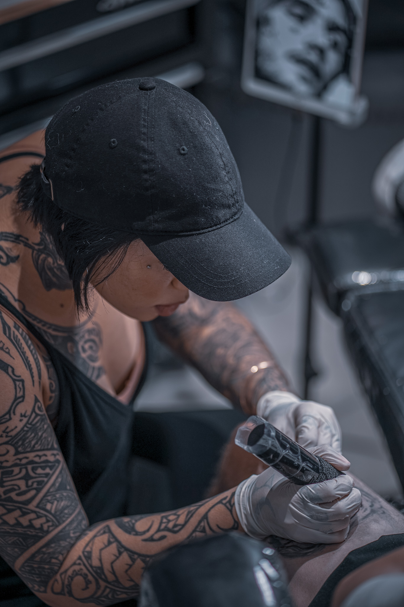 Kai working on a tattoo