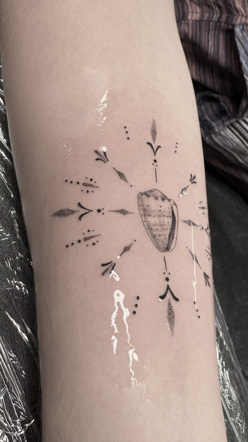 Fine-line cultural tattoo by Kai