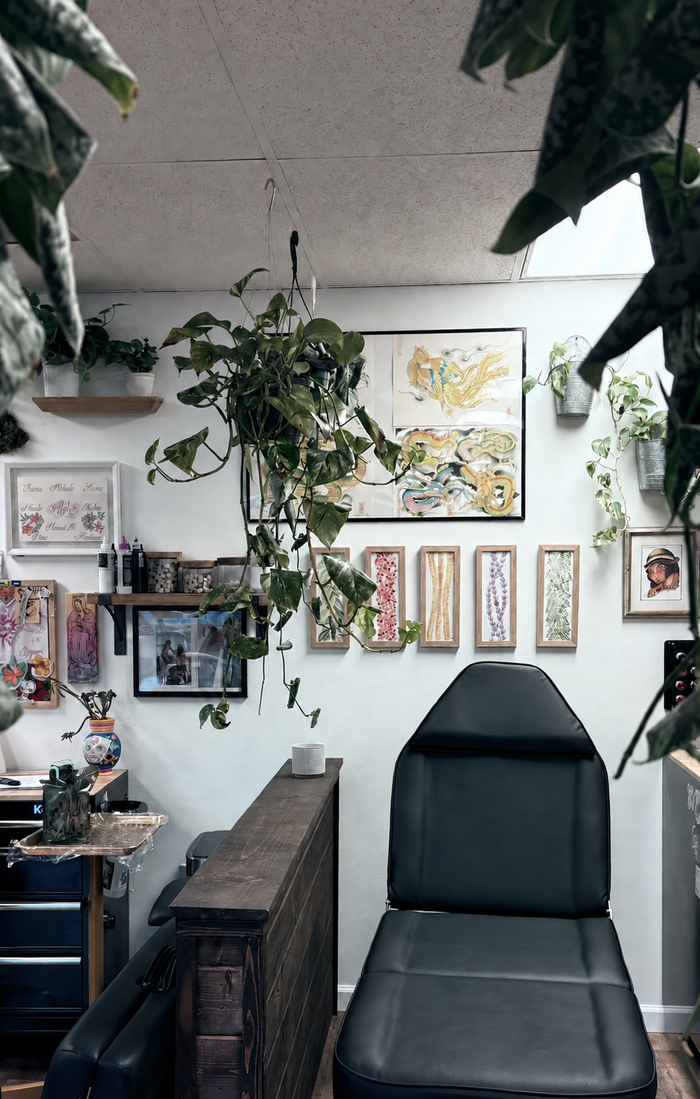 Plant-filled tattoo station inside The Art Den Hawaiʻi